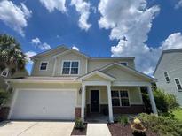 Charming two-story home featuring a well-maintained lawn and inviting front porch at 308 Tidal Rice Ct, Wando, SC 29492
