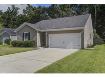 Charming single-story home featuring a two-car garage, neutral siding, and a well-manicured lawn at 3806 Sourwood Ct, Ladson, SC 29456