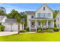 Charming two-story home with a spacious front porch and a detached garage featuring a basketball hoop at 3870 Fifle St, Mount Pleasant, SC 29466