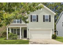 Charming two-story home with light green siding, black shutters, and a well-manicured lawn at 4949 Serene Ln, Hollywood, SC 29449