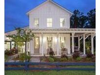 Charming white farmhouse with a welcoming front porch, perfect for enjoying quiet evenings at 617 Saturn Rocket St, Charleston, SC 29492