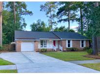 Charming single-story home features a brick facade, manicured lawn, and attached garage at 109 Garbon Dr, Summerville, SC 29485