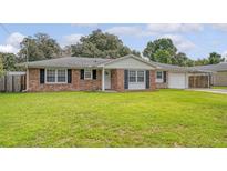 Charming brick home with green lawn, black shutters and attached carport at 113 Jackson Rd, Ladson, SC 29456