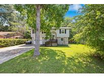 Charming split-level home featuring a well-maintained lawn and a driveway leading to the front entrance at 124 Englewood Rd, Goose Creek, SC 29445