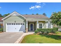 Charming home featuring a well-manicured lawn, a blue front door, and attached two-car garage at 206 Tupelo Lake Dr, Summerville, SC 29486