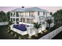 Beautiful two-story home exterior showcases a private pool, balconies, and lush landscaping at 2879 Marshall Blvd, Sullivans Island, SC 29482