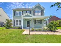 Charming two-story home with a well-manicured lawn and a welcoming front porch at 4847 Cane Pole Ln, Summerville, SC 29485
