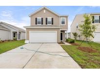 Inviting two-story home with a spacious two-car garage and well-maintained lawn at 5005 Ferry Field Dr, Summerville, SC 29485