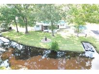 Stunning aerial view of a waterfront home with mature trees and a private dock on a tranquil river at 538 Castlebury Rd, Walterboro, SC 29488