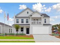Charming two-story home with a two-car garage, landscaped front yard, and classic architectural details at 549 Verdi Dr, Summerville, SC 29486
