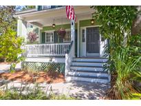Charming front porch with hanging flower baskets, steps, and stylish front door at 794 Hunt Club Run, Charleston, SC 29414