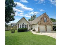 Charming single-story home boasts a well-manicured lawn and a two-car garage, offering both curb appeal and functionality at 8496 Roanoke Dr, North Charleston, SC 29406