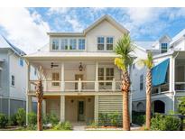 Charming two-story home with a covered front porch and palm trees, creating a welcoming curb appeal at 9017 Stern Aly, Johns Island, SC 29455