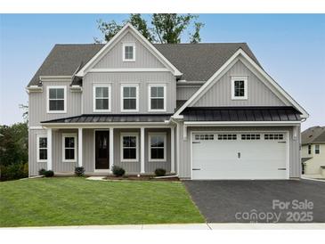 Charming new construction home featuring a gray exterior, lush lawn, and a two-car garage at 11318 James Coy Rd # Devonshire, Davidson, NC 28036