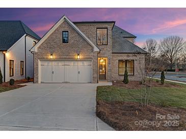 Charming brick home featuring an attached two-car garage and well-maintained landscaping at 8159 Fairview Rd, Charlotte, NC 28226