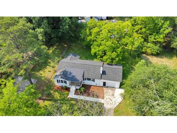 Aerial view of a charming single-story home with a well-maintained yard and mature trees at 506 E Maine Ave, Bessemer City, NC 28016
