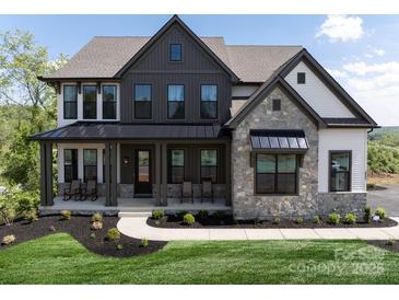 Beautiful two-story home with a stone facade, covered porch, and well-manicured landscaping at 841 Lake Forest Dr # Hawthorne, Belmont, NC 28012