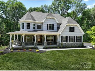 Stunning two-story home with a stone-accented facade and inviting front porch at 843 Lake Forest Dr # Devonshire, Belmont, NC 28012