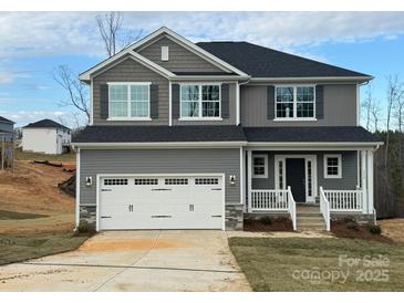 Charming two-story home with gray siding, a white garage door, and a welcoming front porch at 117 High Rock Ct # 09, Statesville, NC 28677