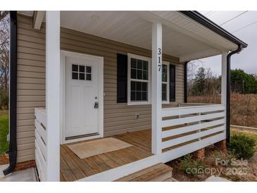 Charming front porch with white railing and new flooring at 317 Blackburn St, York, SC 29745