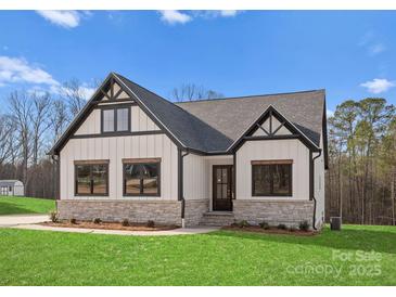 White farmhouse exterior with stone accents and a two-car garage at 179 Heartland Dr # 8, Rock Hill, SC 29732