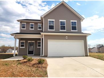 Two-story home featuring a two-car garage, black door, and gray siding at 169 Salem Springs Ln, Statesville, NC 28625