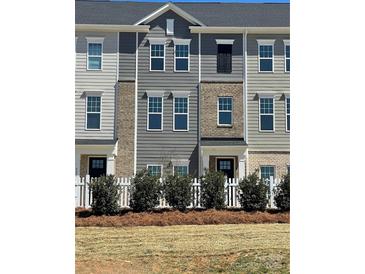 Charming townhome exterior featuring a mix of siding and brick accents, complimented by a neatly landscaped front yard at 4223 S New Hope Rd # 8, Cramerton, NC 28032