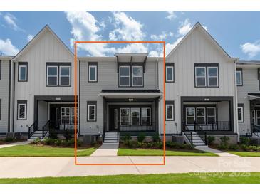 New construction townhome with gray siding, covered entry, and black trim at 413 Prine Pl # Brx0014, Charlotte, NC 28213