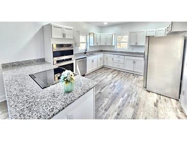 Modern kitchen featuring white cabinets, stainless steel appliances, and granite countertops at 405 Aquadale Rd, Albemarle, NC 28001