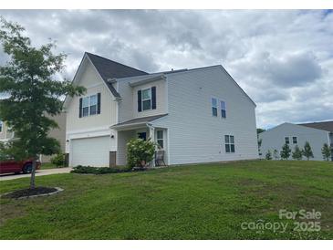 Charming two-story home featuring a well-maintained lawn, attached garage, and classic architectural details at 110 Silver Oak Cir, Rockwell, NC 28138