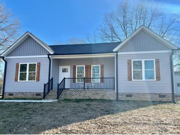 Cute gray house with a black railing and wooden shutters at 325 Jordan Ave, Spencer, NC 28159