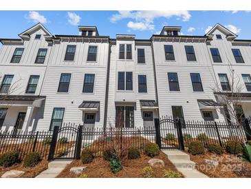 Charming townhome with a light exterior, iron gate, and landscaping at 4210 Alexander View Dr # 38, Charlotte, NC 28226