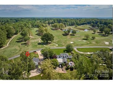 Aerial view of a beautiful property on a golf course with lush greenery and mature trees at 218 Fairway Dr, Shelby, NC 28150