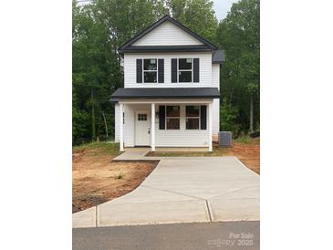 Charming two-story home with a covered porch and freshly poured concrete driveway at 814 W Raleigh W Ave, Statesville, NC 28677
