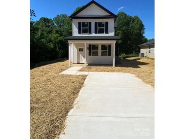 Charming two-story home featuring black shutters, a concrete driveway, and a welcoming front porch at 814 W Raleigh W Ave, Statesville, NC 28677