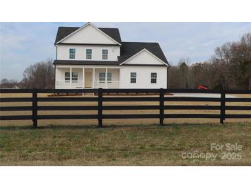 Two-story farmhouse with white siding, black accents, and a front porch at 1187 Philbeck Rd # 13, York, SC 29745