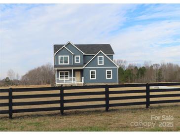 Two-story house with blue siding, white trim, and a black fence at 1169 Philbeck Rd # 12, York, SC 29745