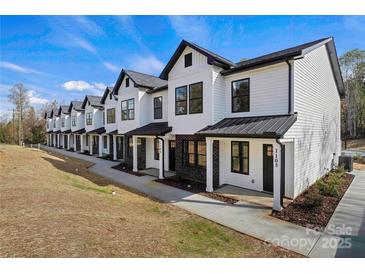 Modern townhome community with white exteriors and black accents at 204 Kimball Rd, China Grove, NC 28023