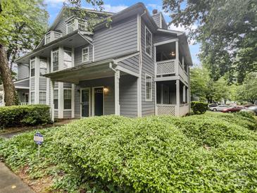 Charming home featuring a covered front porch and two-story balcony with well-maintained landscaping at 6003 Treetop Ct, Charlotte, NC 28212