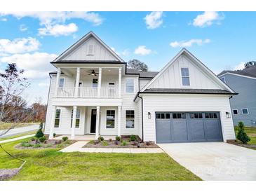 Striking new construction two-story home with a welcoming front porch and two-car garage at 2003 Cedar Falls Dr # 69, Waxhaw, NC 28173