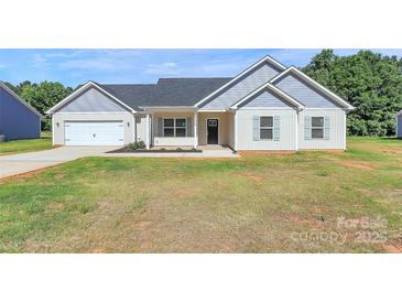 Charming single-story home featuring a landscaped front yard and attached garage, perfect for comfortable living at 6154 Lowder Rd, Salisbury, NC 28147