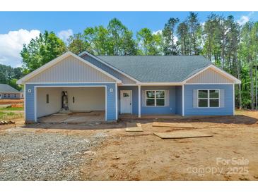 Charming single-story home featuring light blue siding and an attached, open single-car garage at 6133 Long Branch Rd, Salisbury, NC 28147