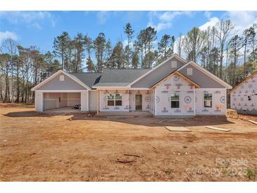 New construction of a single story home, with an attached two car garage, and a partially landscaped yard at 6147 Long Branch Rd, Salisbury, NC 28147