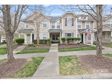 Charming townhome showcasing landscaped front yard and inviting entryway at 17615 Trolley Crossing Way, Cornelius, NC 28031