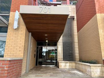 Modern building entrance with water feature and covered entryway at 701 Royal Ct # 309, Charlotte, NC 28202