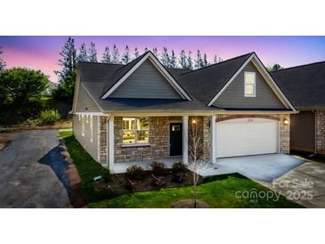 Charming home features stone accents, a two-car garage, and a welcoming front porch at 833 A Wynnshire Dr # 56, Hickory, NC 28601