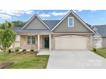 Charming home featuring a stone facade, an attached two-car garage, and a well-manicured lawn at 831 B Wynnshire Dr # 60, Hickory, NC 28601