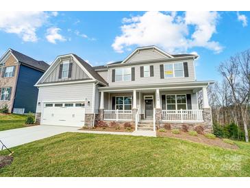 Charming two-story home with a well-manicured lawn, welcoming front porch, and attached two-car garage at 1770 Post Ct # Lot 510, Gastonia, NC 28054