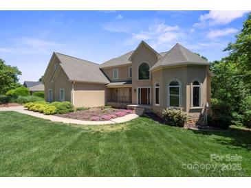 Charming home with manicured lawn, lush landscaping, and a welcoming entrance at 122 Long Cove Ln, Mooresville, NC 28117