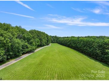 Aerial view of a large lot with expansive green lawn and wooded perimeter, perfect for building a dream home at 6620 Old Concord Rd, Salisbury, NC 28146